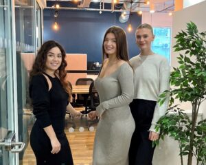 Marina and PR Fire's newest team members pictured in front of the office's co-working space