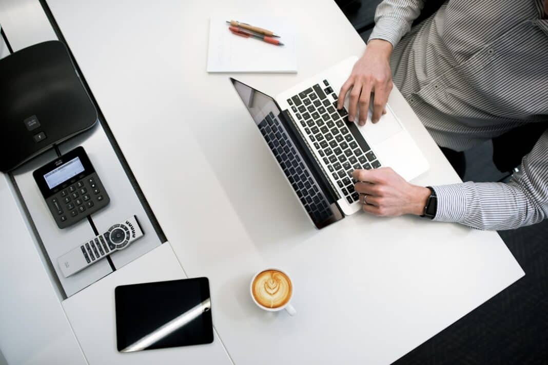 CEO using laptop to learn more about successful sales leadership