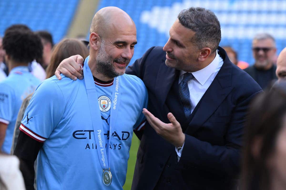 Manchester City's Spanish manager Pep Guardiola (L) speaks with Manchester City Emirati chairman Khaldoon al-Mubarak (R) on the pitch after the presentation ceremony following the English Premier League football match between Manchester City and Chelsea at the Etihad Stadium in Manchester, north west England, on May 21, 2023. Manchester City won the Premier League for the fifth time in six seasons on Saturday, taking a first step to a possible golden treble of trophies as second-placed Arsenal lost 1-0 at Nottingham Forest. (Photo by Oli SCARFF / AFP) / RESTRICTED TO EDITORIAL USE. No use with unauthorized audio, video, data, fixture lists, club/league logos or 'live' services. Online in-match use limited to 120 images. An additional 40 images may be used in extra time. No video emulation. Social media in-match use limited to 120 images. An additional 40 images may be used in extra time. No use in betting publications, games or single club/league/player publications. /  (Photo by OLI SCARFF/AFP via Getty Images)