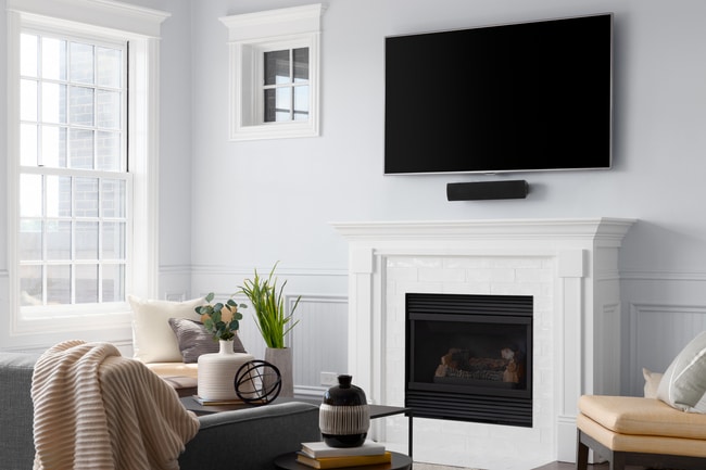 A living room fireplace detail with white subway tiles.